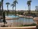 Inviting community pool surrounded by palm trees and a fence, perfect for cooling off and enjoying a swim at 6390 S Granite Dr, Chandler, AZ 85249