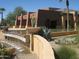 Striking building exterior featuring modern architecture, lush landscaping, and a serene water feature at 6390 S Granite Dr, Chandler, AZ 85249