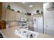 Well-lit kitchen features upper cabinets, light countertops, and white appliances at 6390 S Granite Dr, Chandler, AZ 85249