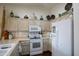 Well-lit kitchen features upper cabinets, light countertops, and white appliances at 6390 S Granite Dr, Chandler, AZ 85249