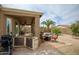 Outdoor kitchen and dining area under covered patio with stone pavers at 6390 S Granite Dr, Chandler, AZ 85249