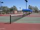 Well-maintained tennis court with net, lights, and covered seating for enjoying a friendly match at 6390 S Granite Dr, Chandler, AZ 85249