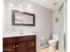 A bathroom featuring dark wood cabinets, a toilet, and a walk-in shower with glass doors at 716 W Nopal Pl, Chandler, AZ 85225