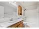 Well-lit bathroom featuring a shower-tub combo, vanity with white countertop, and a light wood cabinet at 716 W Nopal Pl, Chandler, AZ 85225