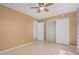 A bedroom featuring a ceiling fan and sliding door closet and a light beige paint at 716 W Nopal Pl, Chandler, AZ 85225