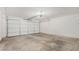 Spacious garage featuring a white garage door and concrete flooring at 716 W Nopal Pl, Chandler, AZ 85225