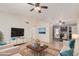 Bright living room with a ceiling fan, tile floors, and modern furnishings at 716 W Nopal Pl, Chandler, AZ 85225