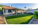 Spacious backyard with lush artificial grass, covered patio area, and well-maintained landscaping at 756 E Appaloosa Rd, Gilbert, AZ 85296