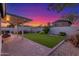 Lovely backyard features a manicured lawn, pavers, and covered patio at 756 E Appaloosa Rd, Gilbert, AZ 85296
