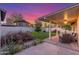 Backyard boasts a covered patio, artificial grass, and landscaping along a block wall at 756 E Appaloosa Rd, Gilbert, AZ 85296