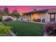 An inviting backyard offers a covered patio and an expanse of manicured artificial grass at 756 E Appaloosa Rd, Gilbert, AZ 85296