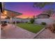 Outdoor living space including turf, hardscape, and seating area under a covered patio at 756 E Appaloosa Rd, Gilbert, AZ 85296