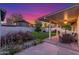 Inviting covered patio with outdoor seating overlooking a well-maintained backyard and manicured landscaping at 756 E Appaloosa Rd, Gilbert, AZ 85296