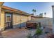 Backyard view featuring a private hot tub, stucco wall, and an exterior door at 756 E Appaloosa Rd, Gilbert, AZ 85296