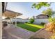 A covered patio with seating overlooks an artificial grass lawn at 756 E Appaloosa Rd, Gilbert, AZ 85296