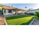 A manicured backyard features artificial grass and a covered patio with seating at 756 E Appaloosa Rd, Gilbert, AZ 85296