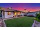 The home features a covered patio and manicured lawn in the backyard at 756 E Appaloosa Rd, Gilbert, AZ 85296