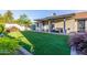 Lovely backyard with artificial grass, covered patio, and comfortable seating for relaxing outdoors at 756 E Appaloosa Rd, Gilbert, AZ 85296