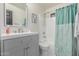 This bathroom features a gray vanity, modern fixtures, and a shower-tub combo at 756 E Appaloosa Rd, Gilbert, AZ 85296