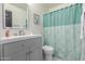 This bathroom features a gray vanity, stylish mirror, and a shower with decorative shower curtain at 756 E Appaloosa Rd, Gilbert, AZ 85296