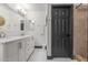 Bright bathroom featuring double sinks, marble countertops, and a step-in shower at 756 E Appaloosa Rd, Gilbert, AZ 85296