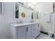 Bathroom featuring a double sink vanity with white cabinets and stone countertops at 756 E Appaloosa Rd, Gilbert, AZ 85296