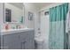 Charming bathroom with a modern vanity, decorative mirror, and shower-tub combo with tile surround at 756 E Appaloosa Rd, Gilbert, AZ 85296