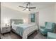 This bedroom features a ceiling fan, bedside table and lamp, and a comfortable sitting chair and ottoman at 756 E Appaloosa Rd, Gilbert, AZ 85296