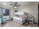 Cozy bedroom features a white bunk bed, a blue accent chair, and wood-look floors at 756 E Appaloosa Rd, Gilbert, AZ 85296