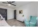 This charming bedroom features a turquoise accent chair, white dresser, and modern light fixture at 756 E Appaloosa Rd, Gilbert, AZ 85296