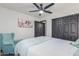 This delightful bedroom has a comfortable accent chair, modern lighting, and ample closet space at 756 E Appaloosa Rd, Gilbert, AZ 85296