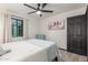 This bedroom features a ceiling fan, large window, artwork, and a sitting chair at 756 E Appaloosa Rd, Gilbert, AZ 85296
