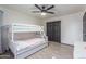 Bedroom featuring a bunk bed, closet, and gray wood-look floors at 756 E Appaloosa Rd, Gilbert, AZ 85296