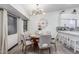 Cozy dining room features a round table, soft chairs, stylish light fixture, and adjacent breakfast bar at 756 E Appaloosa Rd, Gilbert, AZ 85296