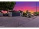 Charming single-story home featuring a lush flowering bush, desert landscaping, and attached garage, enhancing curb appeal at 756 E Appaloosa Rd, Gilbert, AZ 85296