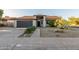Charming single-story home featuring a well-maintained lawn, two car garage and inviting entrance at 756 E Appaloosa Rd, Gilbert, AZ 85296