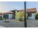 Charming single-story home featuring a lush flowering bush, desert landscaping, and attached garage, enhancing curb appeal at 756 E Appaloosa Rd, Gilbert, AZ 85296