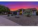 Charming single-story home featuring a lush flowering bush, desert landscaping, and attached garage, enhancing curb appeal at 756 E Appaloosa Rd, Gilbert, AZ 85296