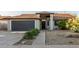 Charming single-story home featuring a well-maintained lawn, two car garage and inviting entrance at 756 E Appaloosa Rd, Gilbert, AZ 85296
