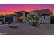 Charming single-story home featuring a lush flowering bush, desert landscaping, and attached garage, enhancing curb appeal at 756 E Appaloosa Rd, Gilbert, AZ 85296