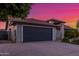 Charming single-story home featuring a lush flowering bush, desert landscaping, and attached garage, enhancing curb appeal at 756 E Appaloosa Rd, Gilbert, AZ 85296