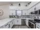 Charming kitchen with white cabinetry, marble countertops, patterned backsplash, and stainless steel appliances at 756 E Appaloosa Rd, Gilbert, AZ 85296