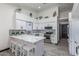 Bright kitchen featuring white cabinets, a spacious island with seating, and patterned backsplash at 756 E Appaloosa Rd, Gilbert, AZ 85296