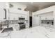 Modern kitchen featuring white cabinets, stainless steel appliances, and an island with marble countertops and bar seating at 756 E Appaloosa Rd, Gilbert, AZ 85296