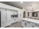 Bright white kitchen featuring an island with marble countertops and decorative backsplash at 756 E Appaloosa Rd, Gilbert, AZ 85296