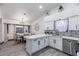 Open kitchen and dining area with white cabinets, marble countertops, and stainless steel appliances at 756 E Appaloosa Rd, Gilbert, AZ 85296