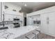 Bright kitchen with white cabinets, stainless steel appliances, and a large marble countertop island at 756 E Appaloosa Rd, Gilbert, AZ 85296