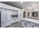 Bright kitchen with white cabinets, stainless steel appliances, and a marble-topped island at 756 E Appaloosa Rd, Gilbert, AZ 85296
