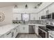 Updated kitchen features white cabinets, stainless steel appliances, marble countertops, and a decorative tile backsplash at 756 E Appaloosa Rd, Gilbert, AZ 85296