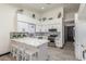 Bright kitchen with white cabinets, stainless steel appliances, marble countertops, and a stylish black-and-white backsplash at 756 E Appaloosa Rd, Gilbert, AZ 85296